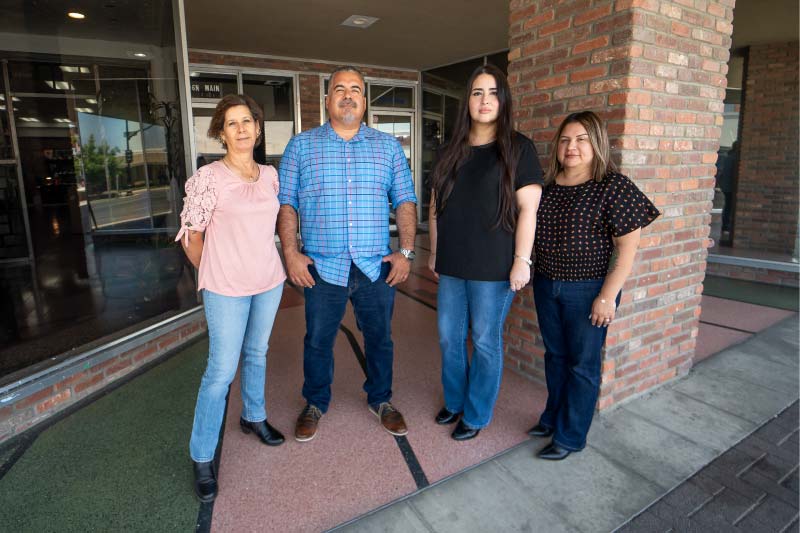 The professional and dedicated team at Direct Capital Lending standing together outside their office building, ready to provide personalized mortgage and refinancing services.