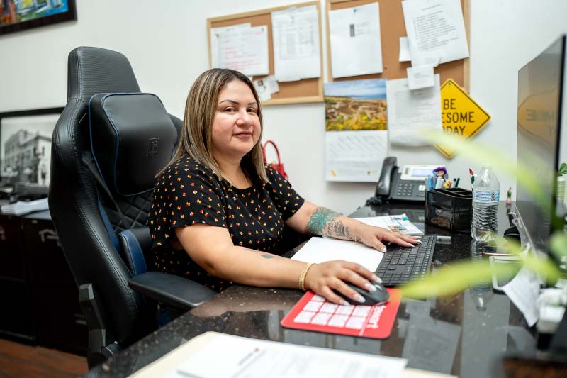 An experienced loan officer working diligently at her desk at Direct Capital Lending, focusing on custom mortgage programs for Central Valley home buyers.